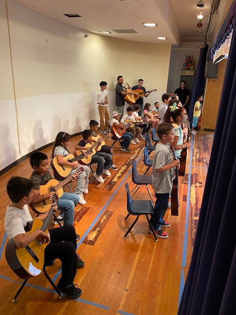 Students playing the guitar